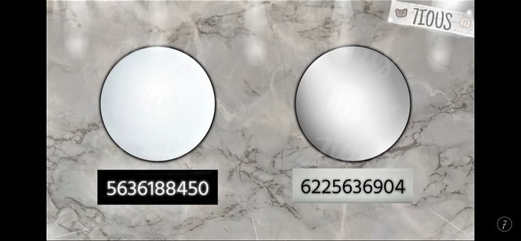 two round mirrors sitting on top of a marble wall