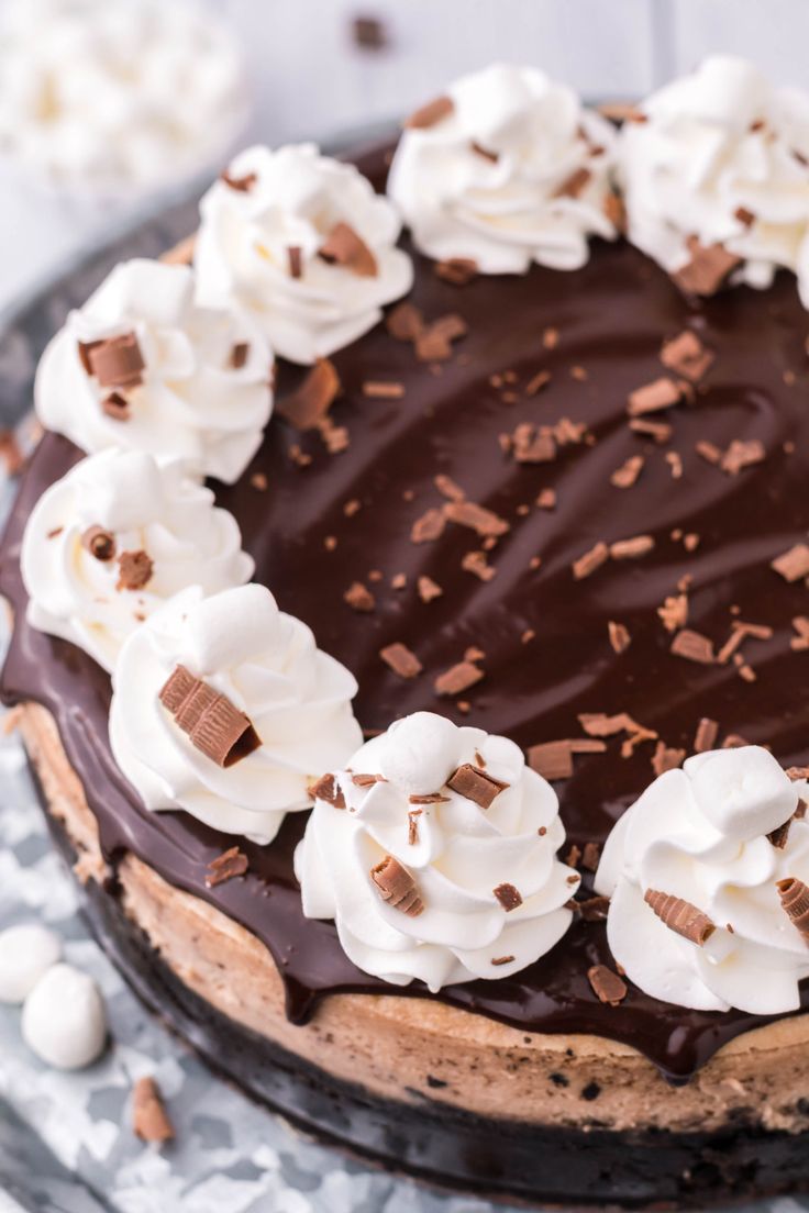 a chocolate cake with whipped cream and chocolate shavings