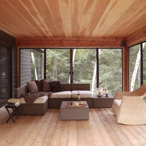 a living room with wood flooring and large windows