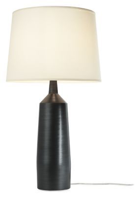 a black table lamp with a white shade on the base and a cord attached to it