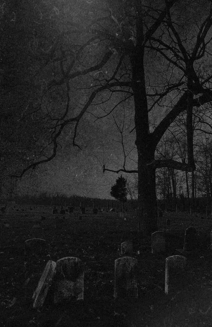 an old cemetery at night with the moon in the sky