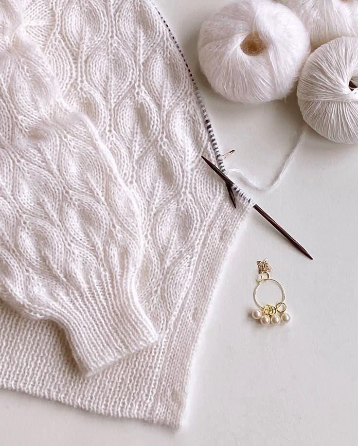 the knitting supplies are laid out on the table to be used for needleing and crochet