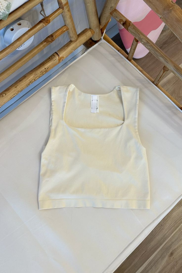 Seamless crop top with a square neckline. 92% Nylon 8% Spandex One size Made in USA High Stretch Scoop Neck Crop Top, Bra Friendly, Stretch Beige Tank Crop Top, Stretch Square Neck Tank Top, Beige Stretch Crop Tank Top, Summer High Stretch Scoop Neck Crop Top, Summer High Stretch Camisole Crop Top, Fitted Seamless Crop Top For Summer, High Stretch Summer Camisole Crop Top, Versatile Seamless Summer Crop Top