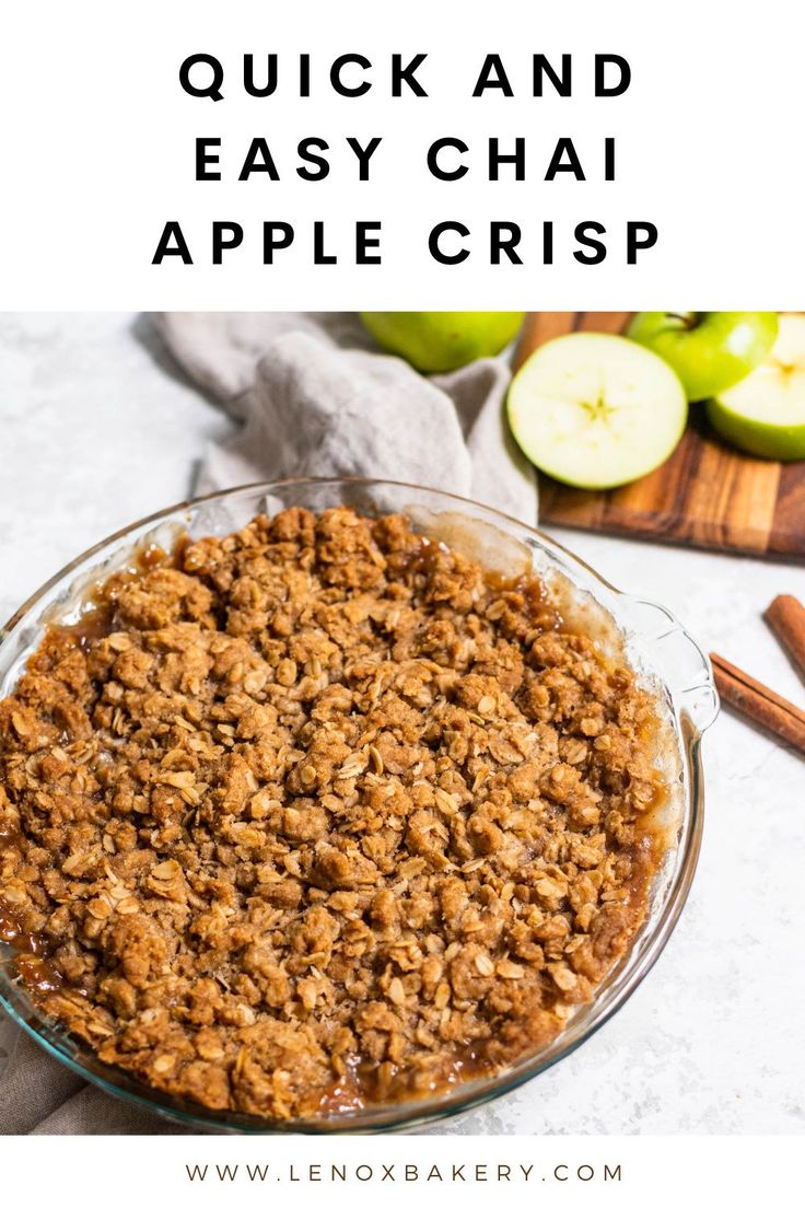 an apple crisp in a glass bowl with cinnamon on the side