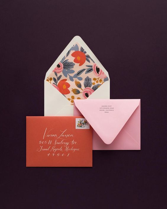 two envelopes, one pink and one orange