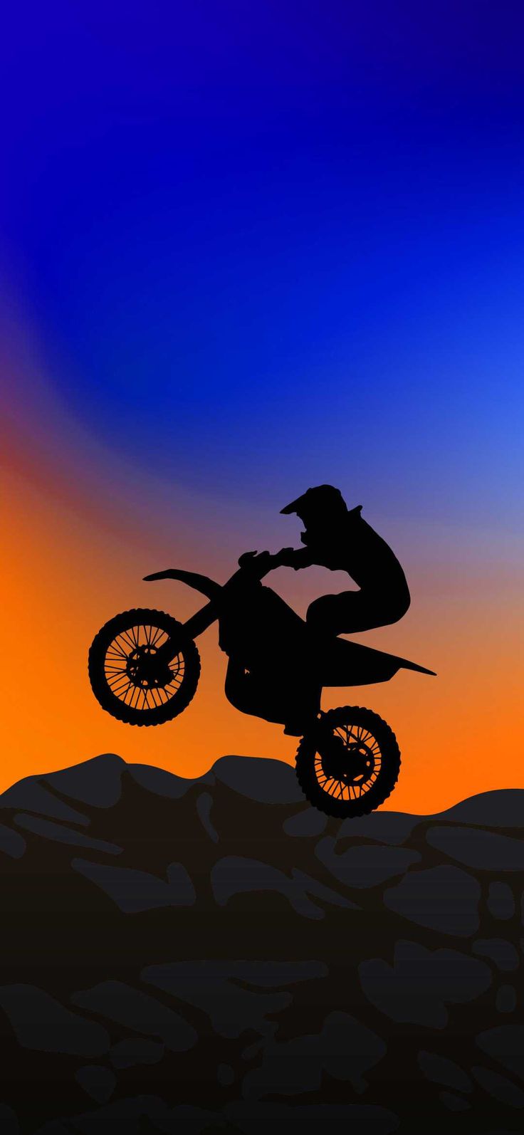 a person on a dirt bike doing a trick in the air at sunset or sunrise