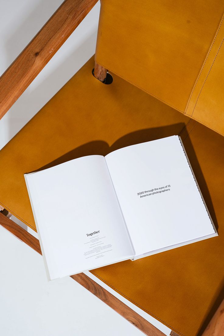 an open book sitting on top of a wooden chair