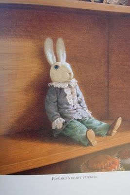 a drawing of a rabbit sitting on top of a wooden shelf