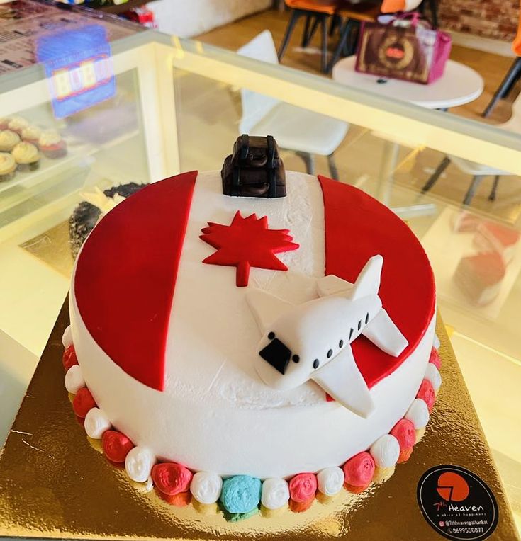 a cake decorated with an airplane and canadian flag