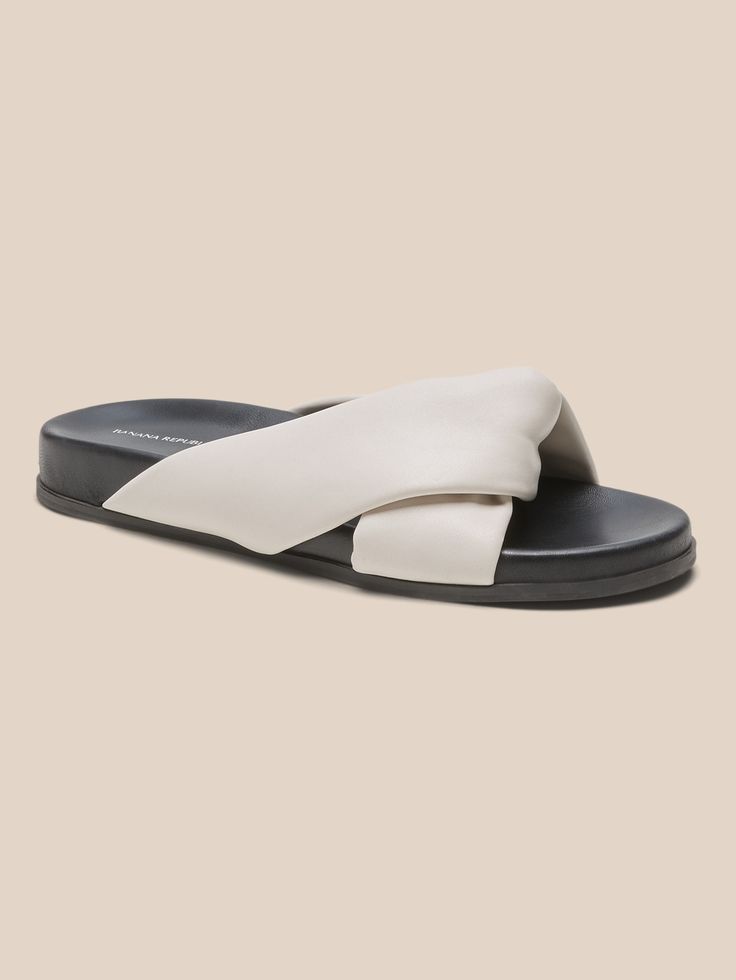 A play with proportions, these soft leather sandals use a twisted leather upper to add an architectural, yet organic feel to these puffy slide sandals.  Try them with breezy maxi dresses or stovepipe-straight jeans.  Leather uppers.  Leather lining. Soft Leather Sandals, Slide Sandals, Maxi Dresses, Straight Jeans, Leather Sandals, Soft Leather, Slip On Sneaker, Banana Republic, Leather Upper