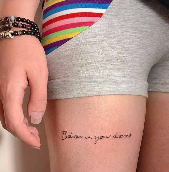 a woman's leg with the words believe in your dreams written on it,