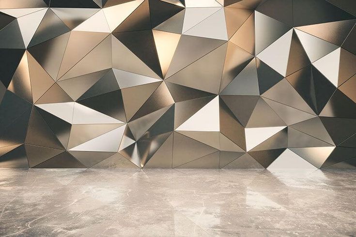 an abstractly designed wall in the middle of a room with concrete floors and walls