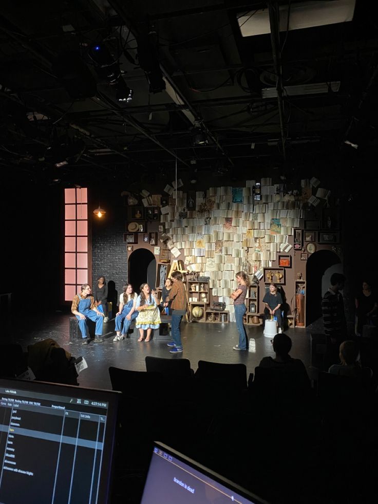 a group of people sitting on top of a stage