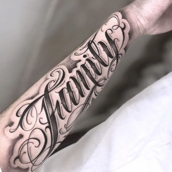 a man's arm with the word family tattooed on it