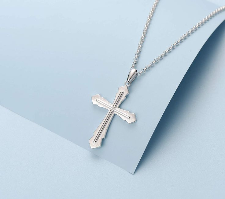 This sleek cross pendant adds protection and a unique look to your wardrobe. This elegant cross is a meaningful look you will appreciate.Materials: Made with whitegold plated 925 sterling silver with sterling silver rolo chain.Necklace Chain: 20 inches (50.8cm) long.Pendant Size: 42 x 23 mm.Chain Type：RoloClasp Type: Lobster Claw Silver Cross Necklace For Streetwear, Silver Cross Pendant Necklace For Father's Day, Father's Day Silver Cross Pendant Necklace, Nickel-free Sterling Silver Elegant Cross Necklace, Adjustable Silver Cross Necklace, Nickel Free, Stainless Steel Cross Pendant Jewelry, Tarnish Resistant, Nickel-free Sterling Silver Cross Pendant, Silver Cross Necklace, Sterling Silver Cross Necklace