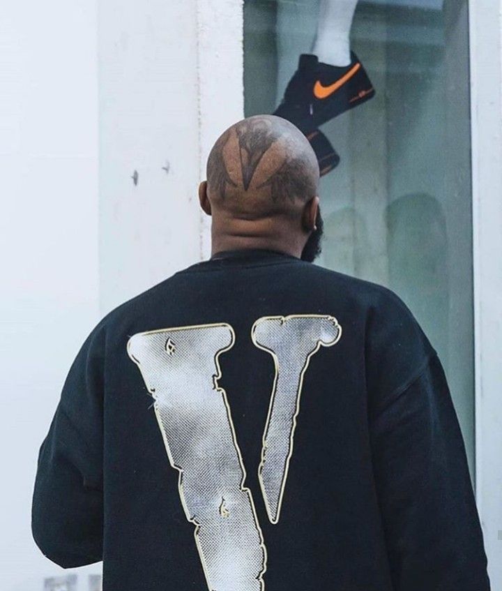 the back of a man wearing a nike jacket