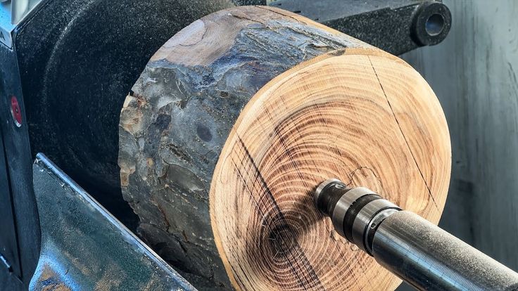 a close up of a machine that is cutting wood