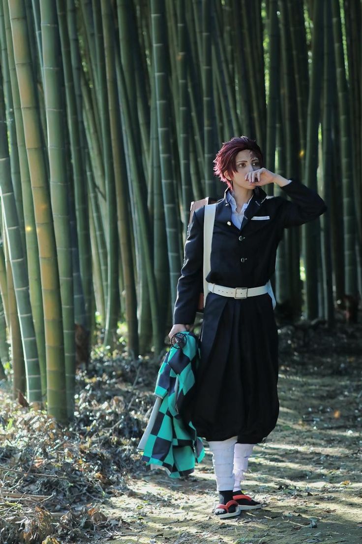 a woman standing in front of a bamboo forest