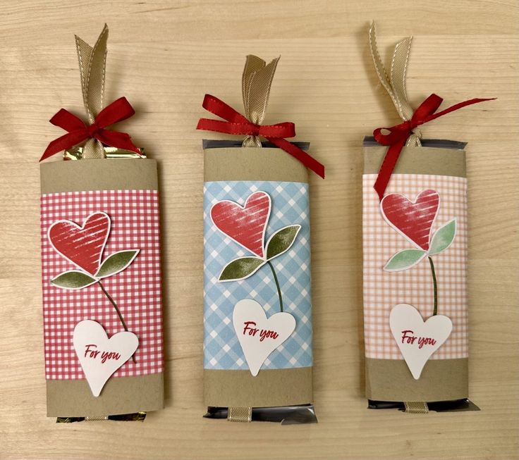 three valentine's day gift bags with hearts and flowers on them