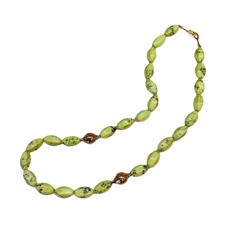 This bright lemon chrysoprase beaded necklace is a celebration of this beautiful light green stone. It is strung with two of our signature crownwork® finials and finished with an 18k yellow gold lilypad clasp. This one of a kind piece looks great layered with other necklaces or worn as a statement on its own. MATERIAL: 18k Yellow Gold STONE TYPE: Lemon Chrysoprase DIMENSIONS: 20" Elegant Green Hand-strung Necklace, Elegant Green Oval Beads Jewelry, Elegant Green Oval Bead Necklaces, Elegant Green Necklaces With Oval Beads, Elegant Green Oval Beaded Necklaces, Green Chrysoprase Jewelry With Faceted Beads, Green Oval Gemstone Beads Jewelry, Green Oval Polished Beads Jewelry, Green Oval Jade Beads Jewelry