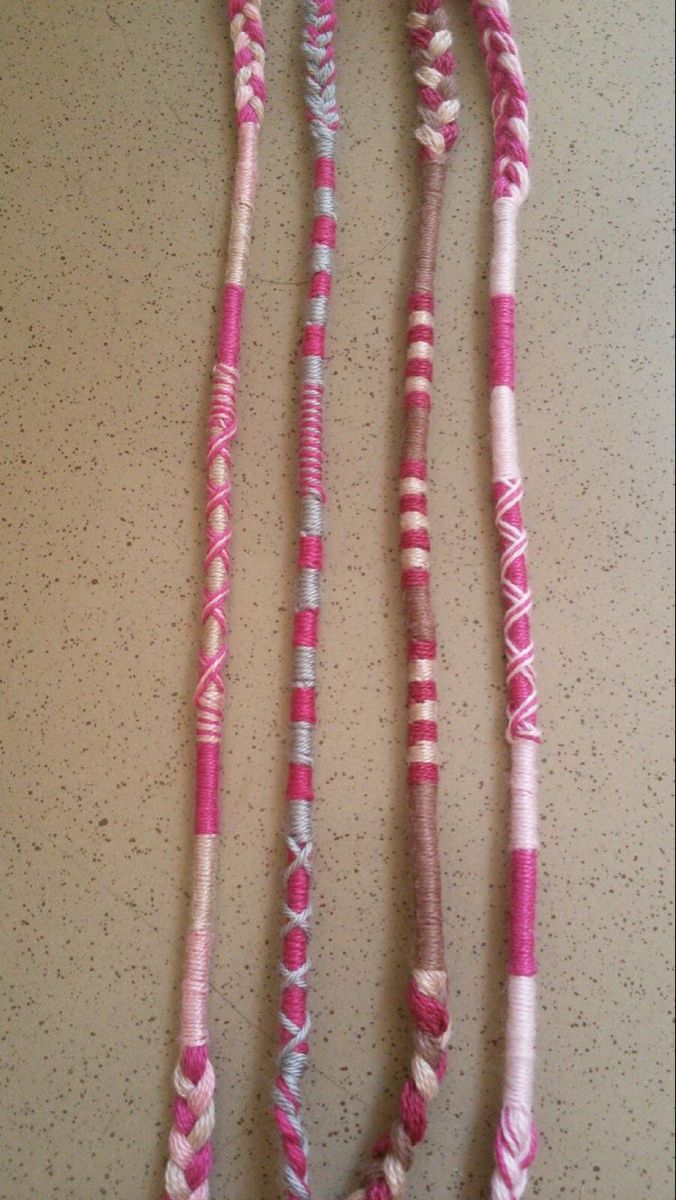 two pink and white necklaces on a table