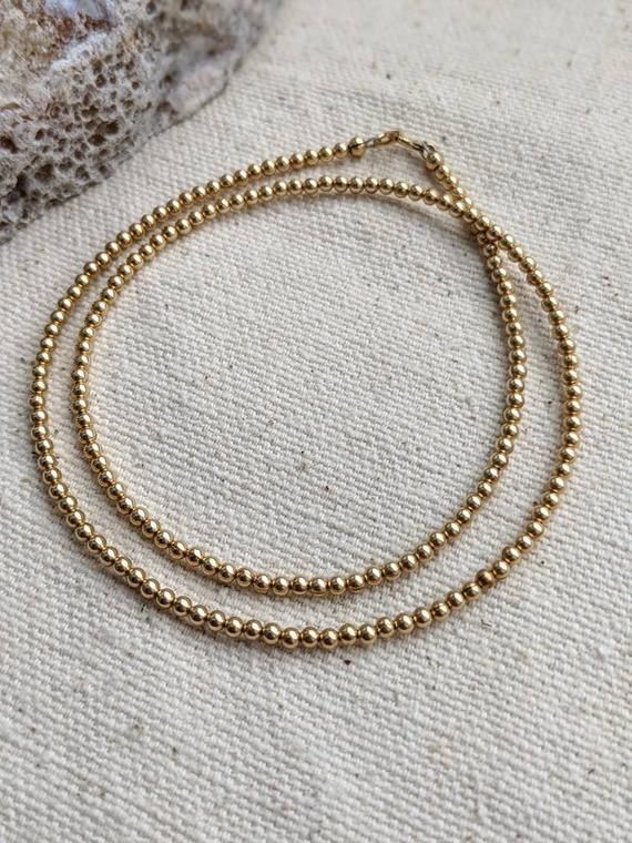 Perfect for your go to every day necklace or addition to your layered look!- 14k gold filled - 2.5mm beads- 6mm spring ring closure Everyday Gold Beaded Necklaces, Gold Double Strand Beaded Necklaces With Tiny Beads, Gold Double Strand Beaded Necklace With Tiny Beads, Everyday 14k Gold-filled Necklaces With Gold Beads, Minimalist 14k Gold-filled Beaded Necklace, 14k Gold Filled Yellow Gold Beaded Necklaces, 14k Yellow Gold Filled Beaded Necklace With Round Beads, Gold Minimalist Polished Bead Necklaces, Minimalist Gold Beaded Necklaces With Polished Beads