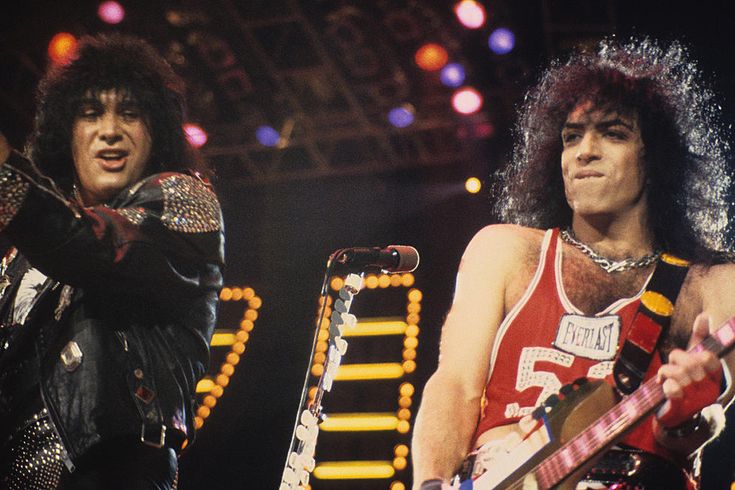 two men with guitars on stage at a concert