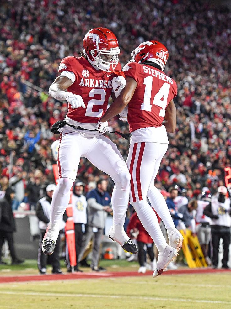 two football players jumping in the air during a game