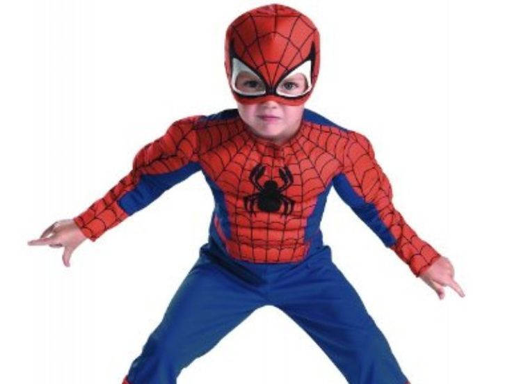 a young boy in a spiderman costume posing for the camera with his hands out