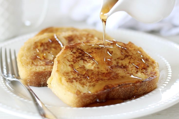 french toast with caramel sauce being drizzled on top