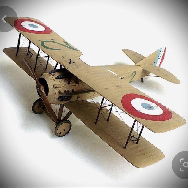 an old model airplane is shown on a white background with red, blue and green markings