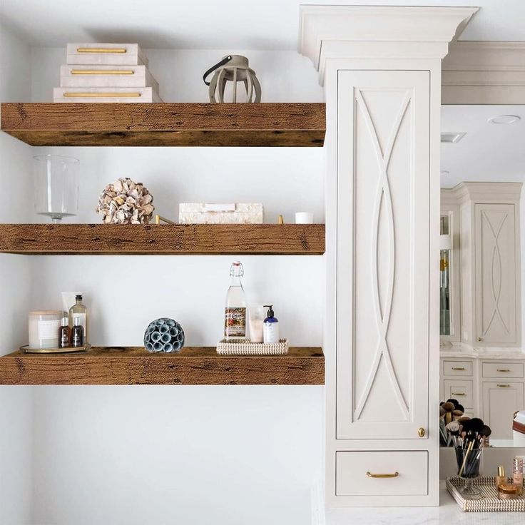 three wooden shelves with candles and other items on them in a white kitchen, next to an open cabinet