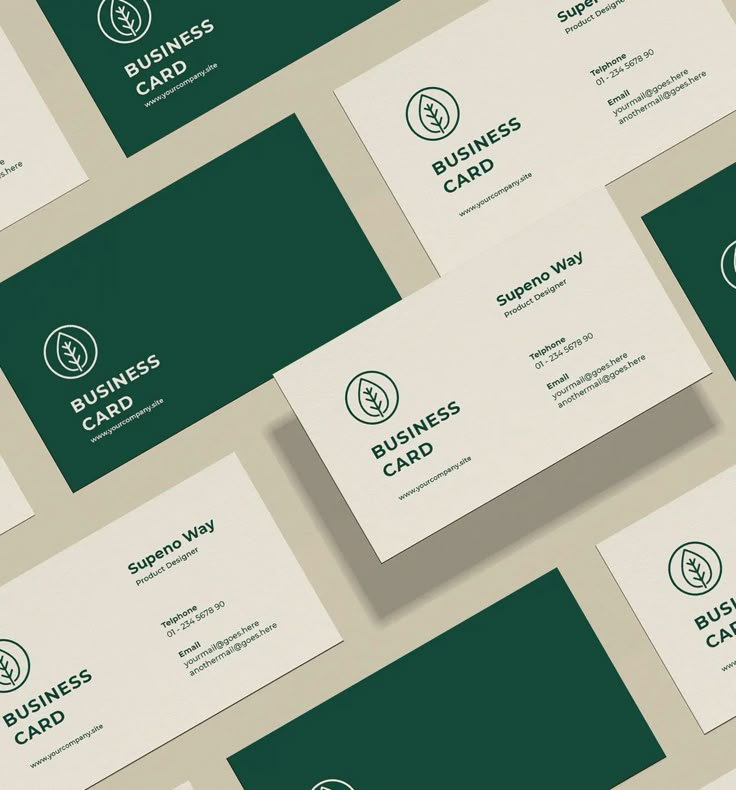 many business cards are stacked on top of each other, with the same logo in green and white