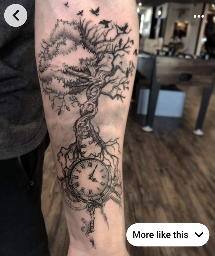 a man's arm with a clock and tree tattoo on it