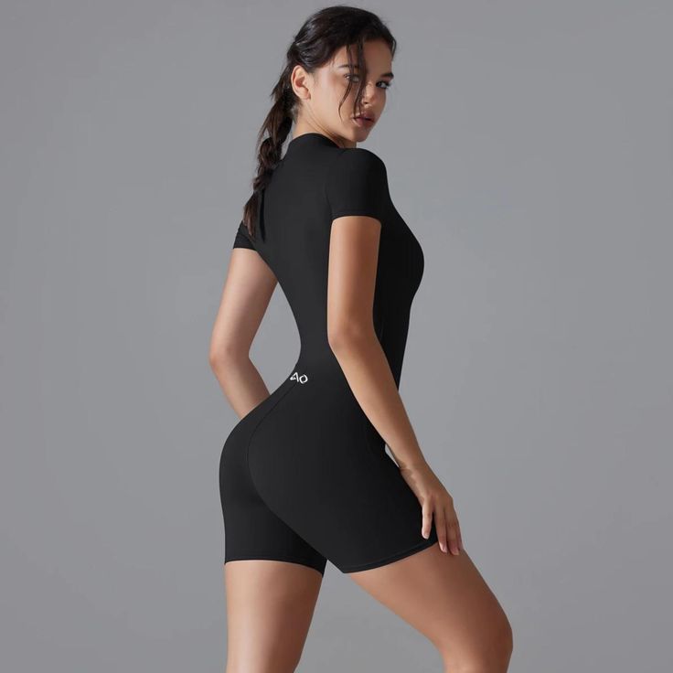 Elevate your activewear collection with the Equilibrium Bodysuit, a perfect blend of style, comfort, and performance. Whether you're flowing through yoga poses or powering through a high-intensity workout, this bodysuit ensures you stay stylish and comfortable.✔️One-Piece Design✔️Zipper Closure✔️Short Sleeves✔️Push-Up Support✔️High-Performance Fabric Black Compression Bodysuit Athleisure, Black Compression Bodysuit For Sport, Black Athleisure Bodysuit For Pilates, Black Athleisure Leotard For Gym, Black Compression Bodysuit Sporty Style, Fitted Moisture-wicking Bodysuit For Training, Black Sporty Leotard For Gym, Moisture-wicking Fitted Bodysuit For Training, Compression Bodysuit For Gym With Seamless Construction