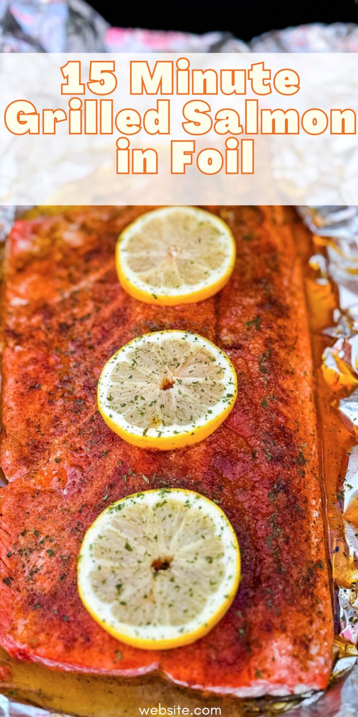 grilled salmon on foil with lemons and herbs in the top right corner for garnish