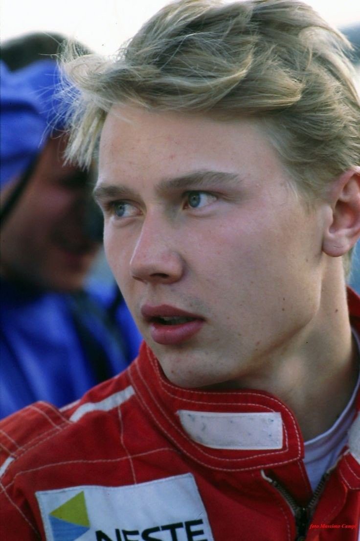 a close up of a person wearing a racing suit