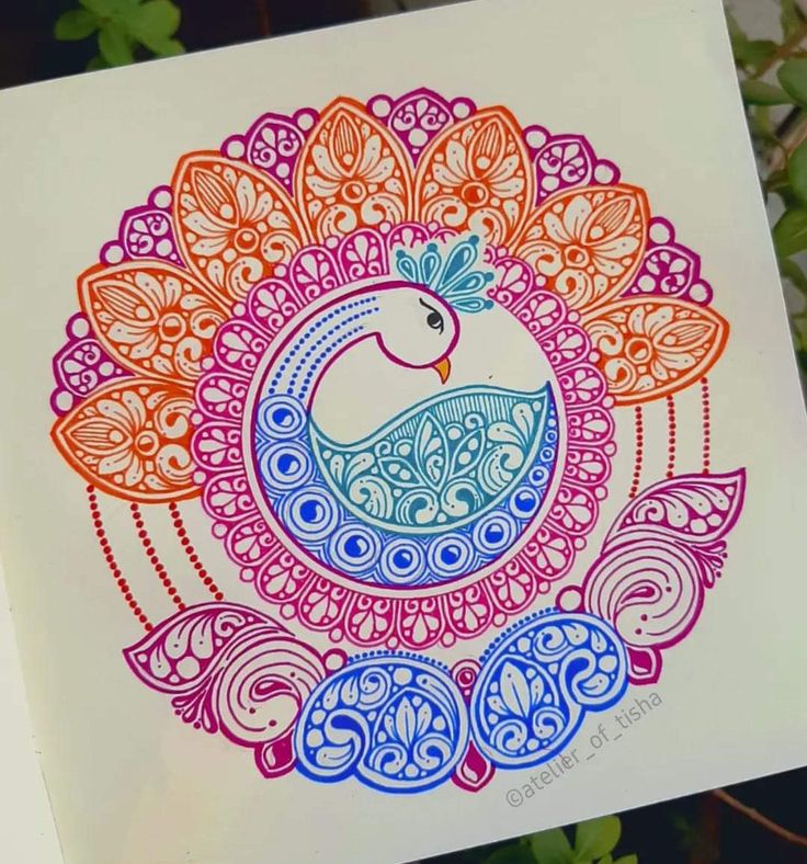 a drawing of a colorful bird on white paper