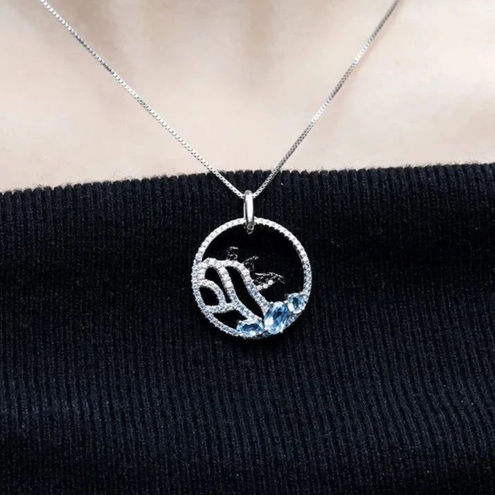 "Dive into a world of Arctic whimsy with our delightful sterling silver and gold necklace, featuring a charming image of three playful penguins frolicking on an iceberg, accented with your choice of blue topaz, nano-sapphire, or rhodolite gemstones. 🐧❄️💎✨ This enchanting piece captures the joy and camaraderie of these beloved creatures in their icy habitat. Meticulously crafted with intricate detailing, the penguins evoke a sense of curiosity and friendship, inviting you to join in their playf Silver And Gold Necklace, Playful Penguins, Sterling Silver Necklaces, Habitat, Blue Topaz, Penguins, Topaz, Silver Necklace, Sapphire