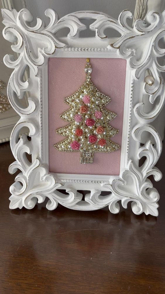 a white frame with a pink christmas tree on the front and gold ornaments in the back