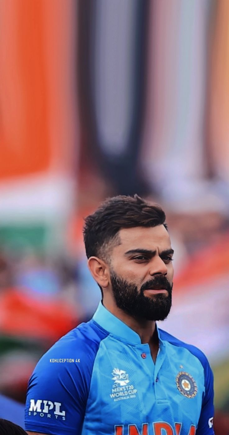 a man with a beard wearing a blue shirt