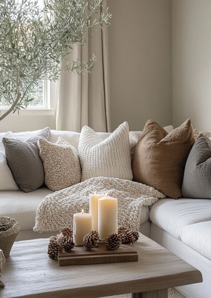 a living room filled with lots of furniture and candles on top of a coffee table