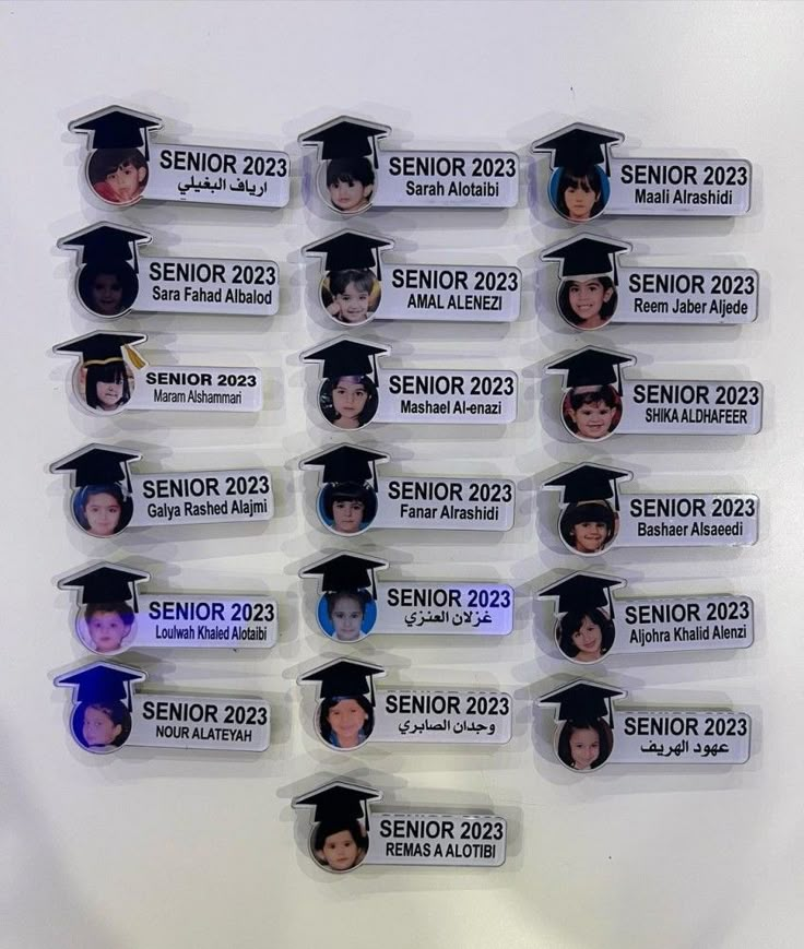 a group of people in graduation caps and gowns with name tags attached to them