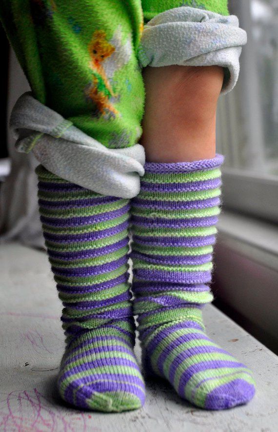 the legs of a child wearing striped socks