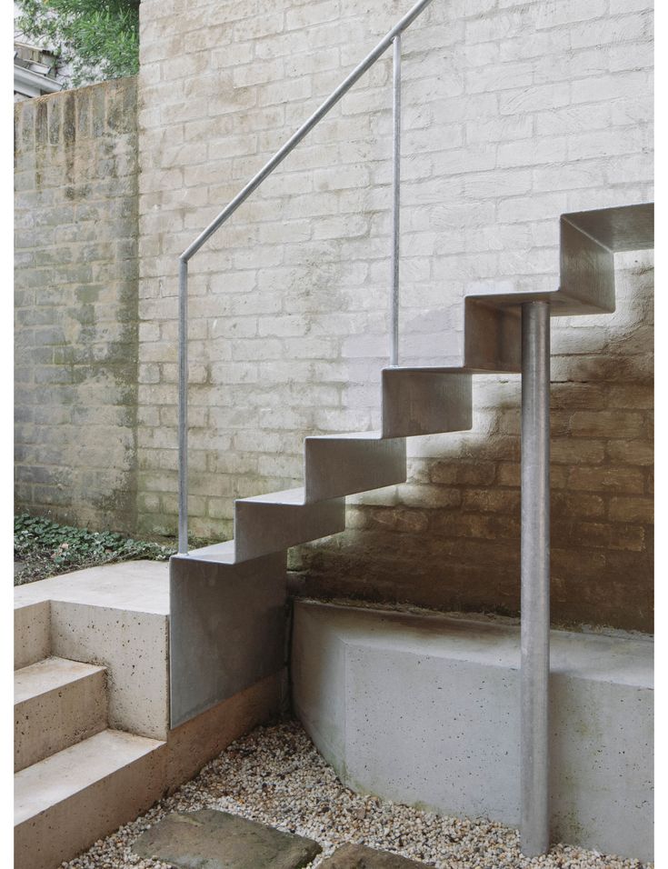 a set of stairs leading up to a brick wall