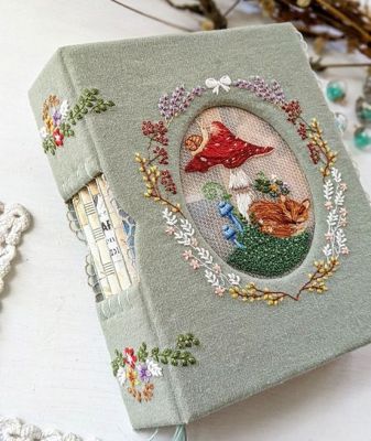 an embroidered book is sitting on a table