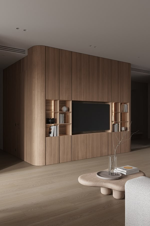 a living room filled with furniture and a flat screen tv mounted on a wooden wall