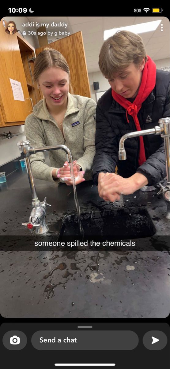 two people are washing their hands in a sink that is filled with water and dirt