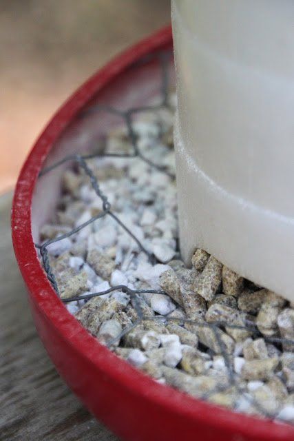 a red bowl filled with rocks and gravel