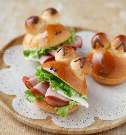 small sandwiches with ham and cheese on buns